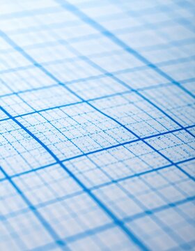 Close-up abstract of a blue grid pattern on white paper, soft focus
