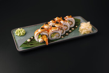 Shrimp tempura sushi rolls on plate with wasabi and ginger © AntAlexStudio