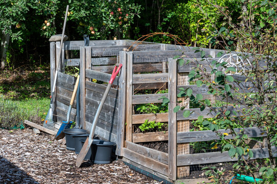 Homemade garden compost with garden tools and buckets