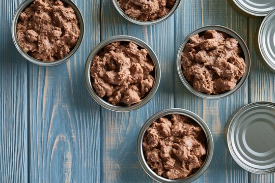 The Canned Pet Food Pate on a Blue Wooden Table