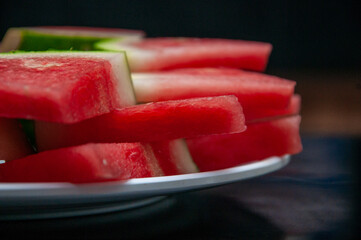  show fresh, ripe watermelon slices arranged neatly on a plate © And