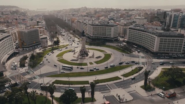 Traffic Navigating Marques De Pombal Square Roundabout Leading Into Avenue Liberdade In Lisbon City Centre, Portugal. - aerial shot