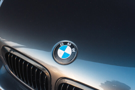 Banjar City, Indonesia - August 22, 2026: Sign of a BMW logo on black car. Chrome grille reflects ambient light subtly. Vehicle exudes elegance and precision