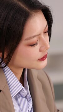 Asian Businesswoman Smiling While Working in Corporate Office