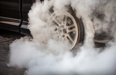 Drag racing car is burning tires at start line. © toa555