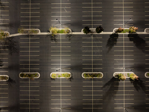 Overhead shot of a vacant parking area, illuminated at night
