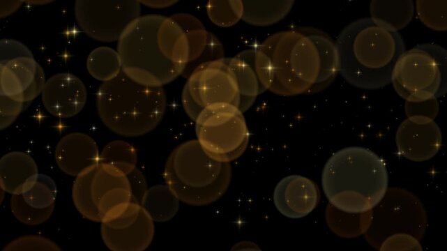 Soft gold bokeh circles drifting behind sharp twinkling sparkles on a black background creating a layered depth of field between the foreground and the distance