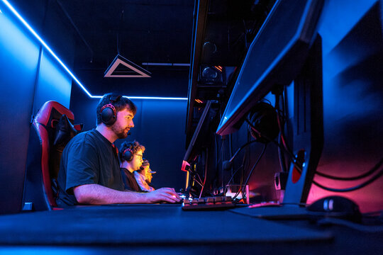 Young man plays competitive game on computer