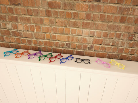 Colourful glasses on shelf