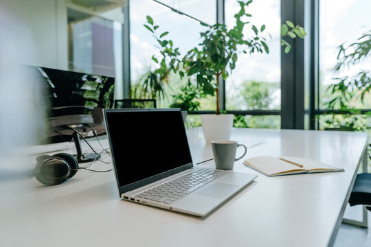 Modern empty office desk with laptop and copy space