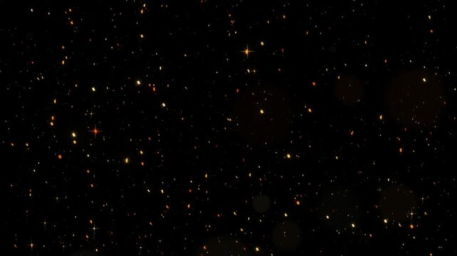 Amber embers and orange sparks rising on a black background with drifting ash glitter for fire and festival motion overlays