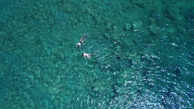 Couple Snorkeling in Clear Turquoise Water Top View