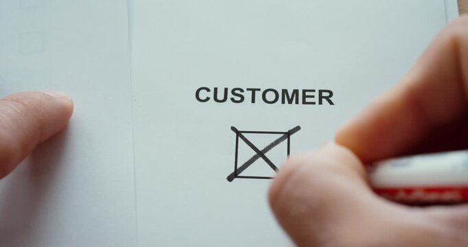 Close-up of a person marking a &ldquo;Customer&rdquo; checkbox on a form, representing customer identification, consumer surveys, market research and business data collection.