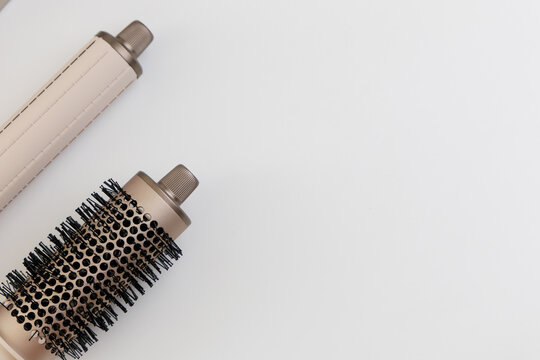 Tools for hairstyling placed on a plain white surface for organization and easy access during use