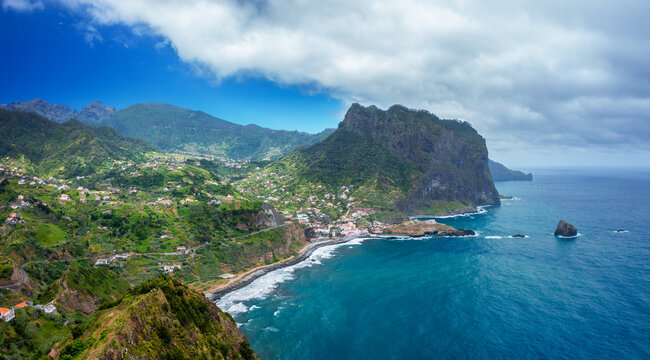 Spectacular coastal view of the majestic Penha d'Aguila rock mountain rising over the blue sea bay of Porto da Cruz, Madeira, Portugal.
