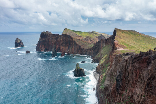 Majestic panoramic view of the volcanic rock cliffs and deep blue ocean bays at Ponta de Sao Lourenco, Madeira, Portugal.
