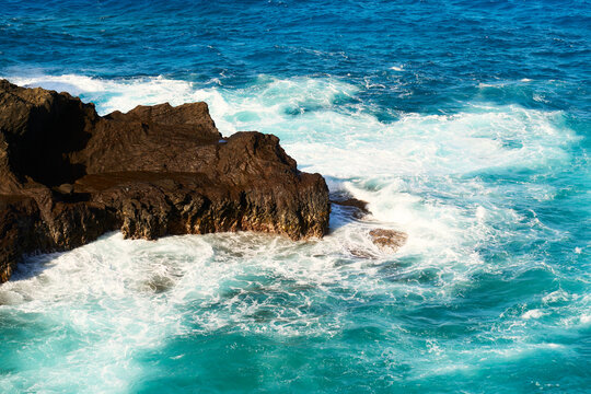 Ocean waves crashing on rocky coastline at Oahu, Hawaii