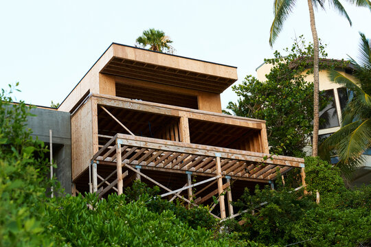 House under construction with wood framing in tropical Oahu setting