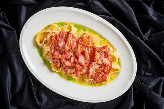 Delicious slow-cooked meat served on a plate with vibrant sauce and fresh garnishes