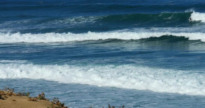 Slow-motion video of a surfer braving heavy swell