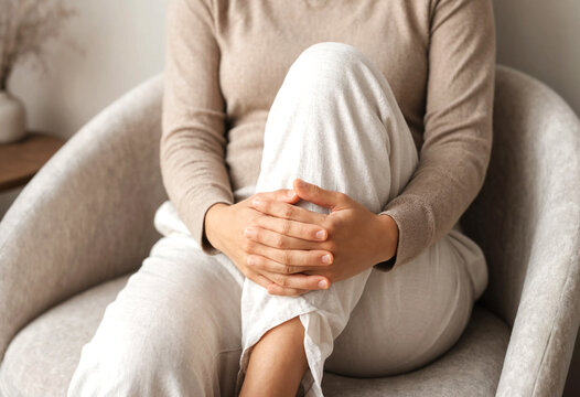 Person sitting comfortably wrapped in a towel on a light colored couch