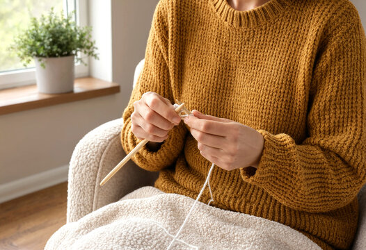 Woman Knitting Cozy Sweater Using Wooden Knitting Needles At Home