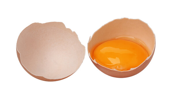 Broken eggshell with bright yellow yolk inside on a plain background