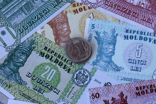 Moldovan leu money notes and coins on table. Moldova cash bills of MDL currency close up