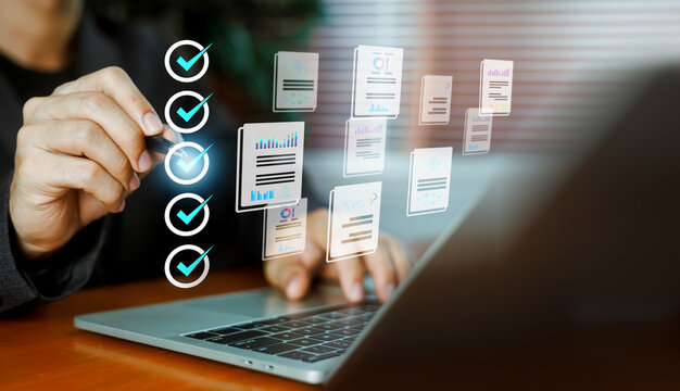 Business person checking virtual checklist items and document reports while typing on a laptop. Concept of task management, quality control, workflow automation, and corporate compliance.
