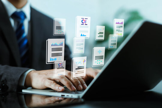 Businessman typing on a laptop with flying virtual document and data report icons. Concept of digital document management, business workflow automation, corporate reporting, and data analytics.