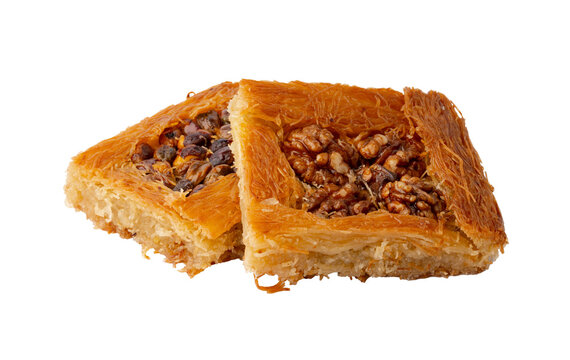 Baklava with nuts on a white plate in a kitchen setting