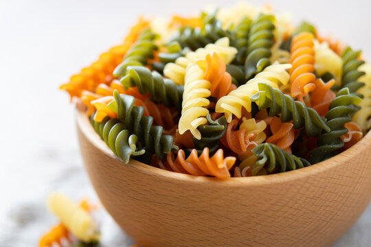 Dry tricolor fusilli pasta in bowl