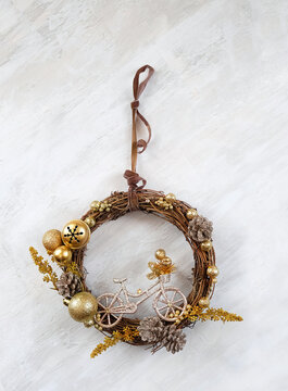 festive decor for Christmas, New year holidays. beautiful decorative wreath with bicycle figurine on light background. seasonal diy Gift idea for bicyclist. top view. copy space