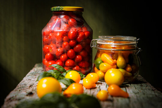 red and yellow cherry tomatoes in a jar for winter