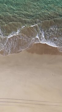 Aerial Top Down View of Ocean Waves Washing Sand Shoreline