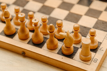 playing chess, white chess pieces are placed in rows on black and white chessboard before game beginning © Anton Pentegov