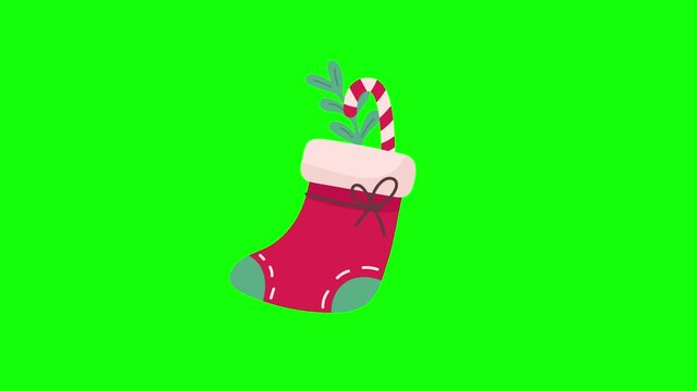 Vibrant festive Christmas stocking with candy cane and evergreen branch, ready for holidays on green screen.