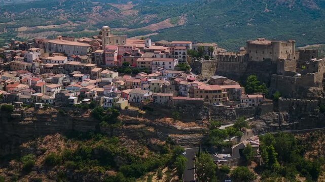 Santa Severina medieval hill town 70mm drone pan in Calabria Italy 4K. Castle and houses perched on tufa cliff. One of the most beautiful villages of Italy hidden gem cinematic aerial view