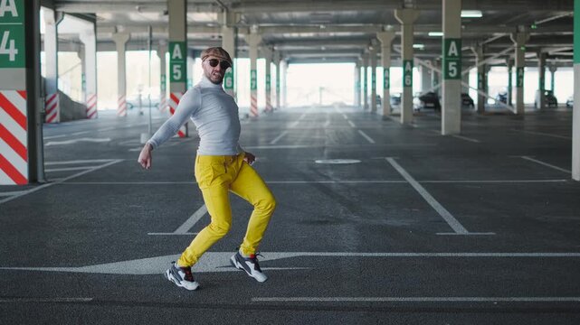 Street dancer moving freestyle in the city. Urban hip hop culture and energetic performance
