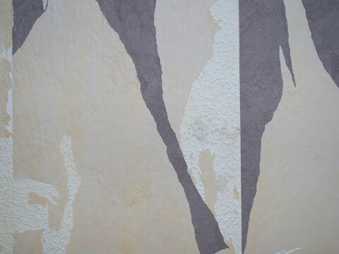 Torn Abstract Wallpaper Layers in Dark Grey and Cream Shades on White Textured Wall, Creative Vintage Wall Art Texture for Background, Interior Renovation with Ripped Paper Patterns Close Up