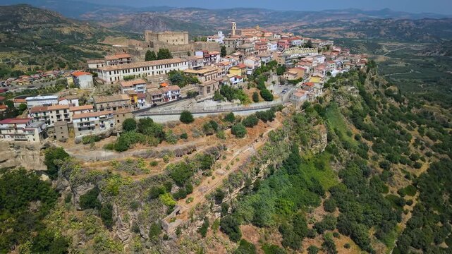 Santa Severina wide angle aerial view with drone turn over medieval borgo Calabria Italy 4K. Olive groves on slopes and mountain valley. One of the most beautiful villages hidden gem