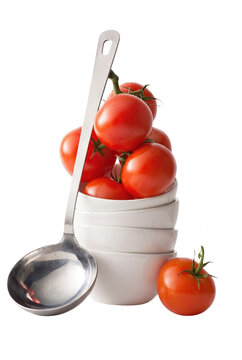 Fresh Red Tomatoes Overfilling Stacked White Bowls with a Silver Ladle
