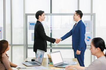 Asian business partnership meeting greeting handshake conversation project success marketing workgroup discussing growth ideas information communication company professional teamwork collaboration. © Bangkok Click Studio