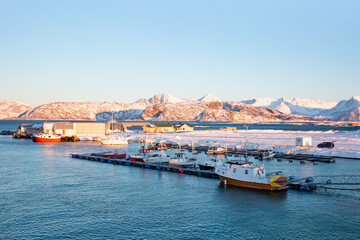 Fototapeta premium Beautiful winter landscape with red house (cabin) on the background sea sunset - Tromso, Norway