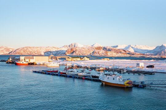 Beautiful winter landscape with red house (cabin) on the background sea sunset - Tromso, Norway