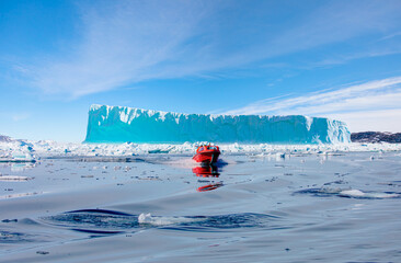 Melting icebergs by the coast of Greenland, on a beautiful summer day - Melting of a iceberg and pouring water into the sea - Greenland © muratart