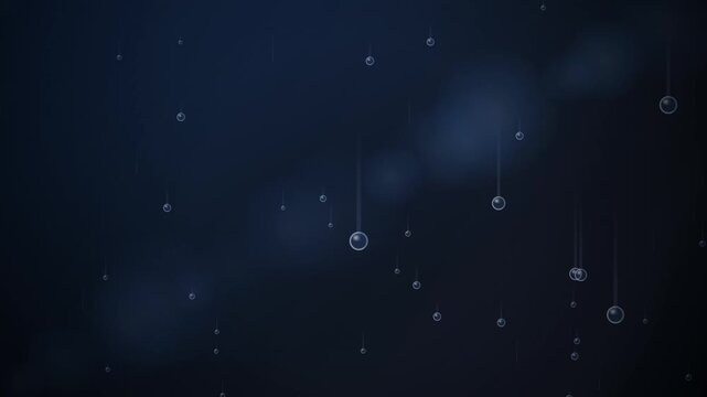 Delicate blue spheres hang from thin strings in a softly illuminated dark space.