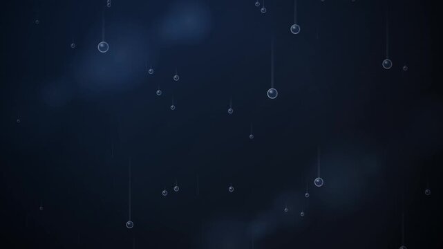 Suspended circular metallic spheres dangle on thin threads against a dark blue background with subtle bokeh lighting.