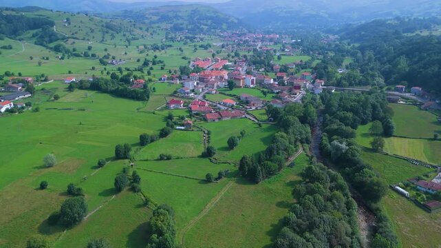 Aerial drone view of the summer countryside surrounding the village of Villacarriedo in the Pasiegos Valleys, Cantabria, Spain, Europe