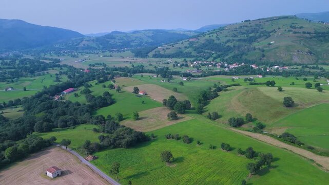 Aerial drone view of the summer countryside surrounding the village of Villacarriedo in the Pasiegos Valleys, Cantabria, Spain, Europe